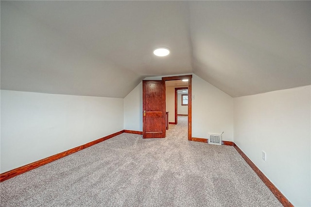 additional living space with light carpet and lofted ceiling