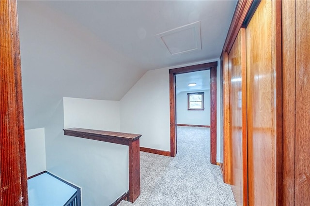 hall featuring light carpet and lofted ceiling