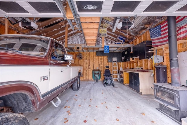 garage featuring wood walls and a garage door opener