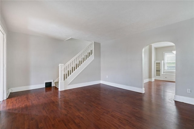 unfurnished room featuring dark wood-type flooring