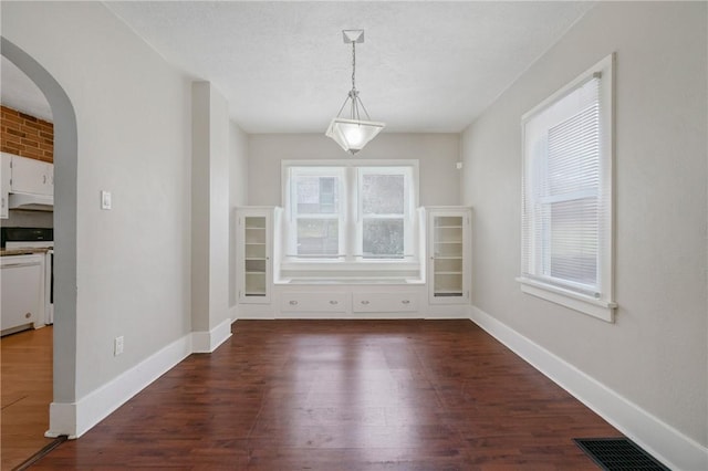 unfurnished dining area with dark hardwood / wood-style flooring