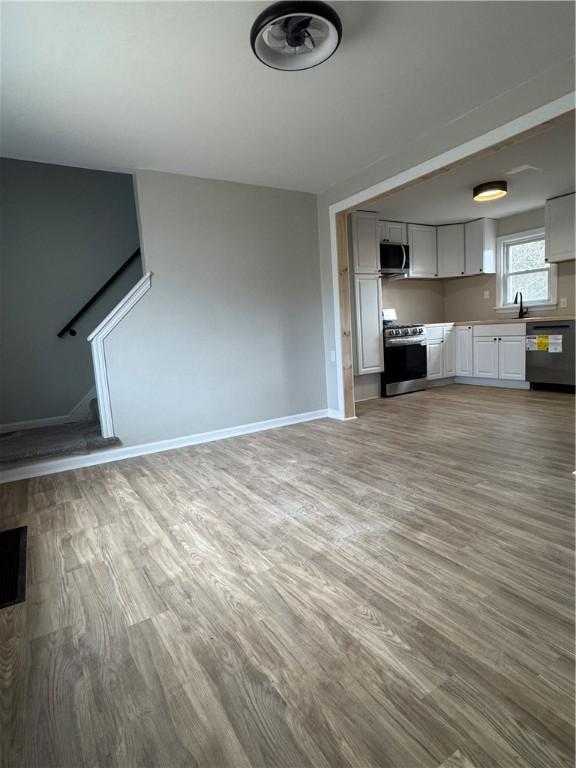 unfurnished living room with light wood-type flooring