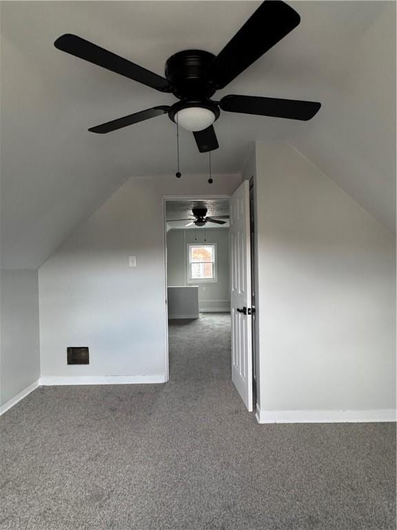 bonus room featuring lofted ceiling and dark colored carpet