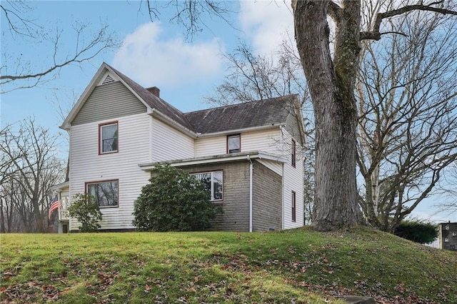 view of side of property with a yard