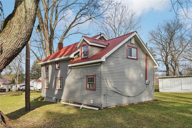 view of side of home featuring a lawn