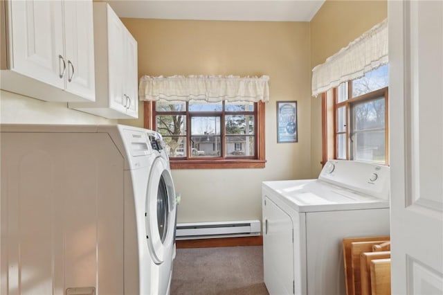 washroom featuring a healthy amount of sunlight, washing machine and dryer, and a baseboard heating unit