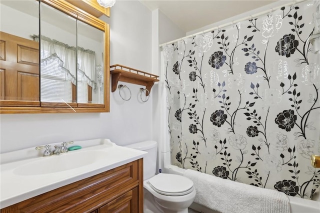 full bathroom with vanity, shower / tub combo, and toilet