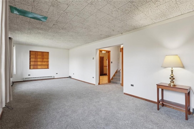 unfurnished room featuring carpet flooring, crown molding, built in features, and a baseboard heating unit