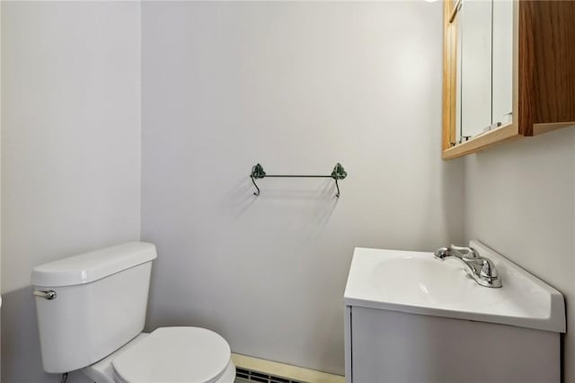 bathroom with vanity, toilet, and baseboard heating