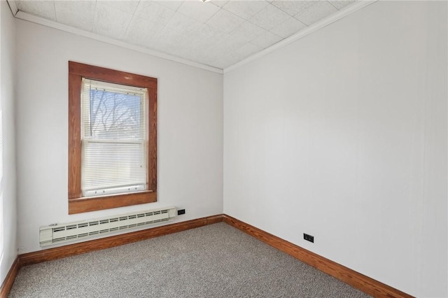 spare room featuring carpet floors, a baseboard radiator, and crown molding