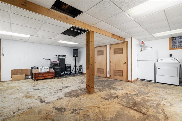 basement featuring washer / clothes dryer and white fridge