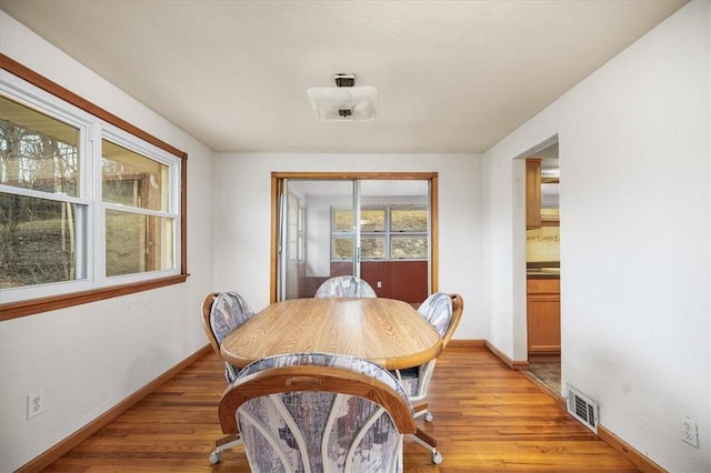 dining space with light hardwood / wood-style floors