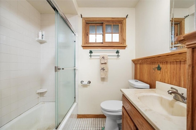 full bathroom with vanity, toilet, and combined bath / shower with glass door