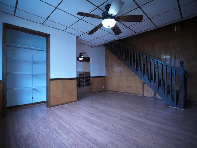 unfurnished living room with a paneled ceiling, ceiling fan, and hardwood / wood-style floors