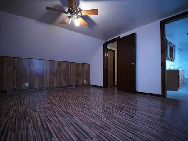 additional living space featuring ceiling fan and dark wood-type flooring