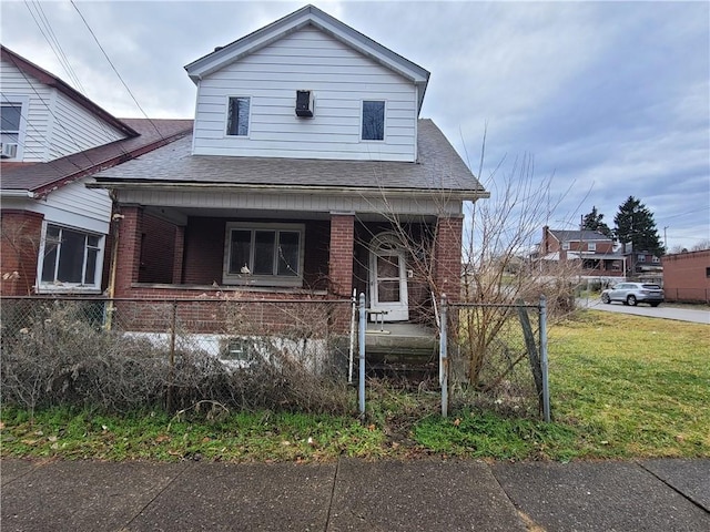 view of front of property featuring covered porch and a front lawn