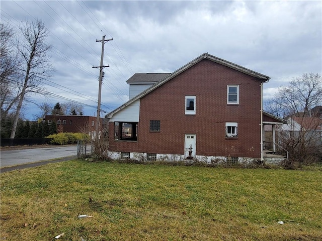 view of property exterior featuring a lawn