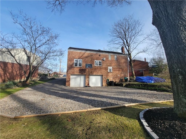 rear view of house featuring a garage