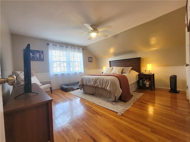 bedroom with hardwood / wood-style floors, ceiling fan, and lofted ceiling