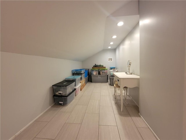 bathroom featuring vaulted ceiling