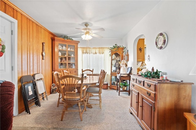 dining room with ceiling fan and light carpet