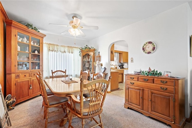 carpeted dining area featuring ceiling fan