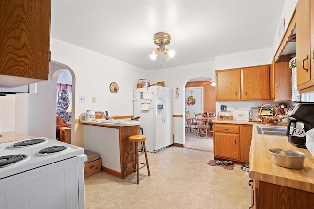 kitchen featuring white appliances and sink