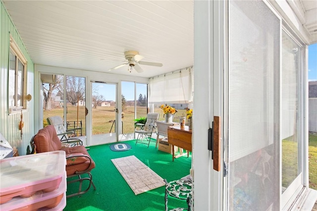 sunroom / solarium featuring plenty of natural light and ceiling fan