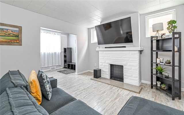 living room featuring light hardwood / wood-style floors and a fireplace