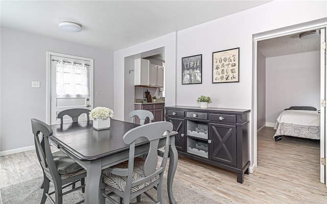 dining space with light wood-type flooring