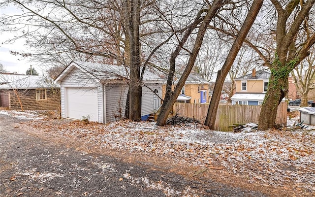 yard covered in snow with a garage