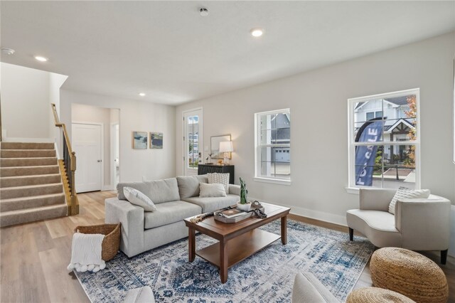 living room with a healthy amount of sunlight and light hardwood / wood-style flooring