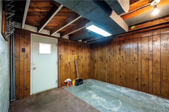 basement featuring wood walls