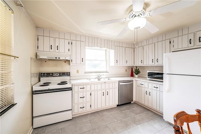 kitchen featuring sink, ceiling fan, light tile patterned floors, appliances with stainless steel finishes, and white cabinetry