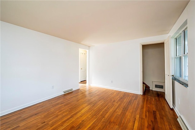 unfurnished room with dark hardwood / wood-style flooring