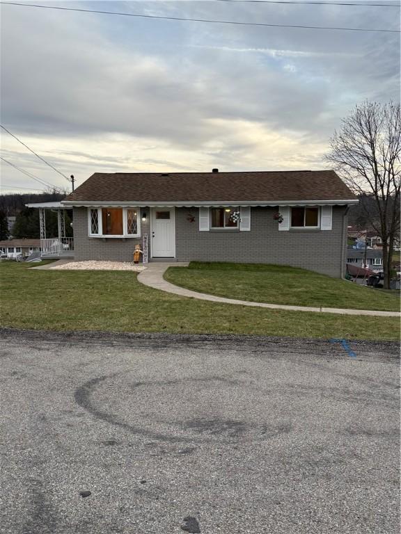 ranch-style home with a front lawn