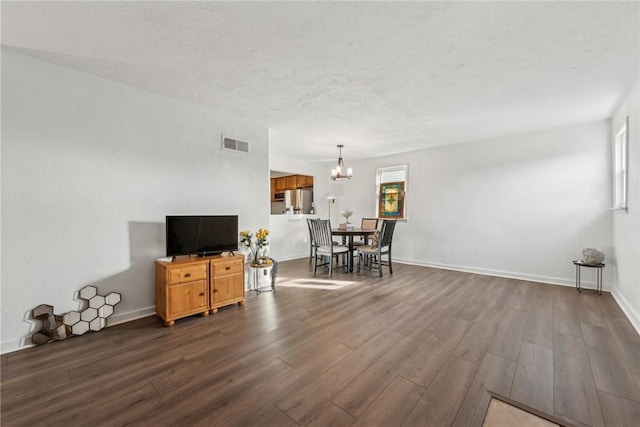 living room featuring dark wood-type flooring and a chandelier