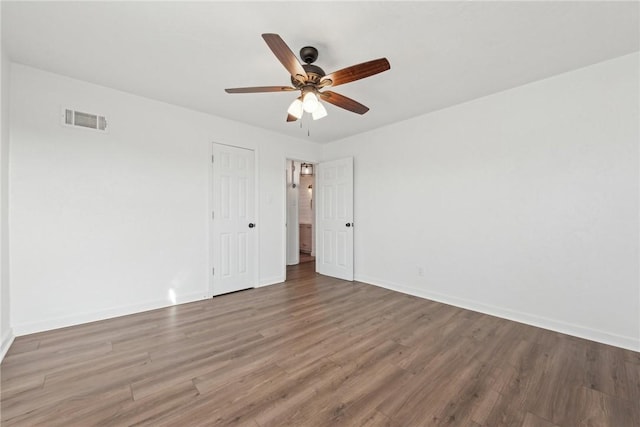 unfurnished room with hardwood / wood-style floors and ceiling fan