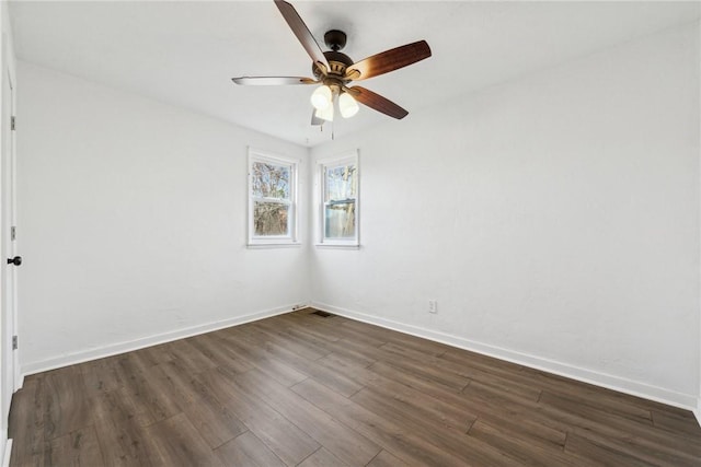 spare room featuring dark hardwood / wood-style floors and ceiling fan