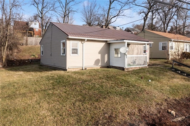 rear view of house with a yard