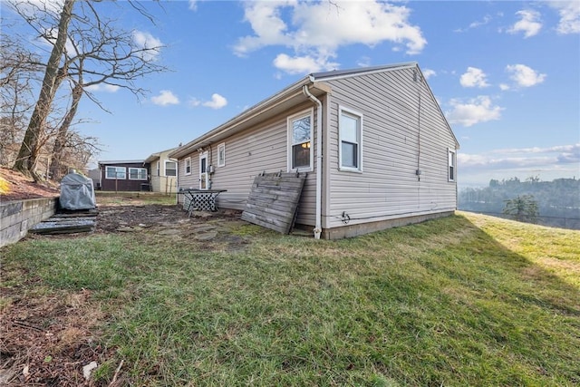 view of side of home with a lawn