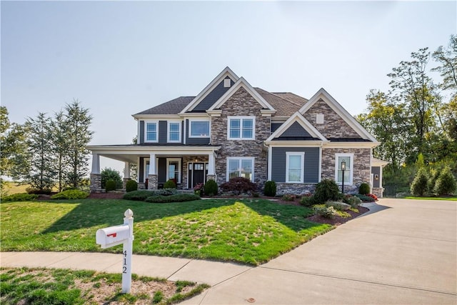 craftsman-style house with a porch and a front yard