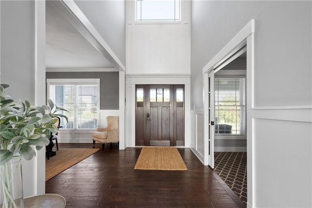 entryway with dark hardwood / wood-style flooring and ornamental molding