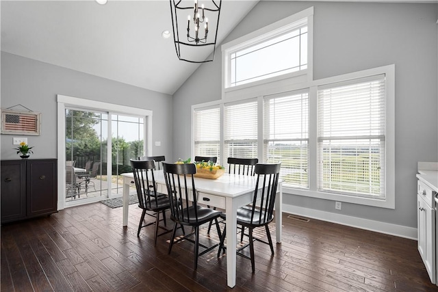 dining area with dark hardwood / wood-style flooring, high vaulted ceiling, and a notable chandelier