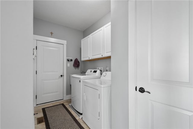 washroom with cabinets and independent washer and dryer