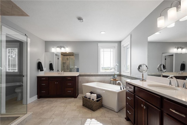 full bathroom with tile patterned flooring, vanity, toilet, and independent shower and bath