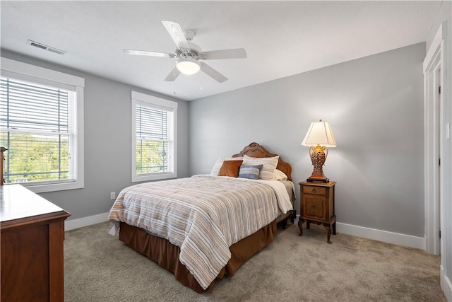 bedroom with ceiling fan and light colored carpet