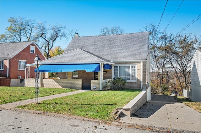 bungalow-style home with a front yard