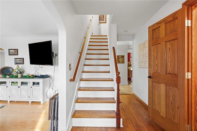 stairway featuring wood-type flooring