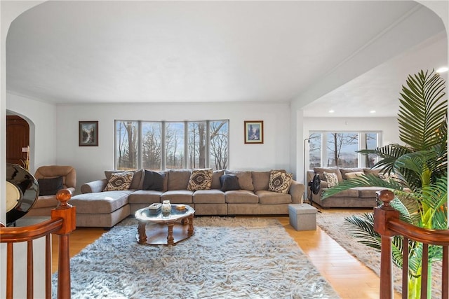 living room with light hardwood / wood-style flooring and crown molding